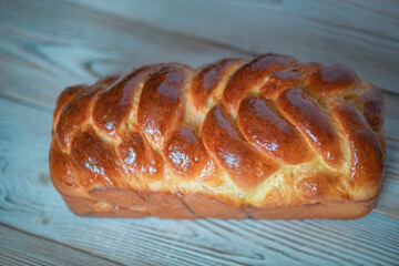 Fresh baked homemade organic bread close-up on a wooden background.