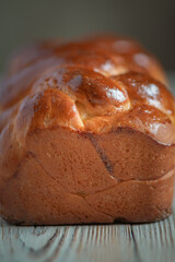 Fresh baked homemade organic bread close-up on a wooden background.
