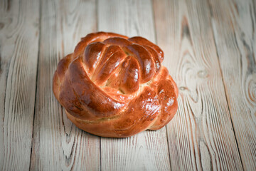 Fresh baked homemade organic bread close-up on a wooden background.