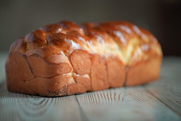 Fresh baked homemade organic bread close-up on a wooden background.