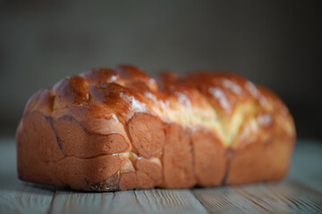Fresh baked homemade organic bread close-up on a wooden background.