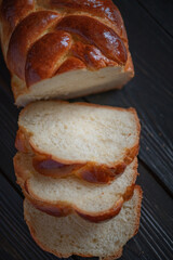 Fresh baked homemade organic bread close-up on a wooden background.