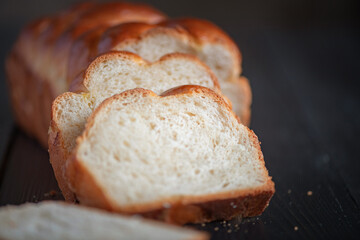 Fresh baked homemade organic bread close-up on a wooden background.