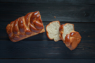 Fresh baked homemade organic bread close-up on a wooden background.