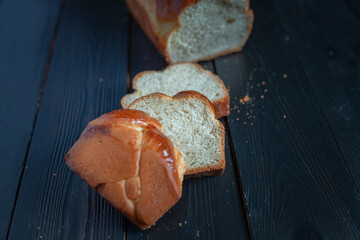 Fresh baked homemade organic bread close-up on a wooden background.