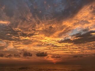 Abstract nature cloud background. Dramatic and moody orange, yellow and little bit of blue clouds sunset sky