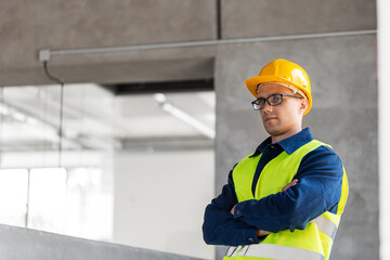 architecture, construction business and building concept - male architect or builder in helmet and safety west at office
