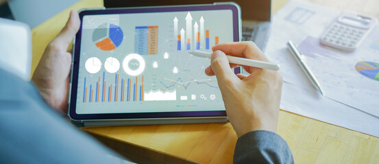 close up businessman point on tablet to working about planning business strategy , forecasting...