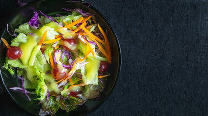 Top view of homemade menu healthy vegetable salad of fresh tomato, Topped with salad dressing cooking on plate