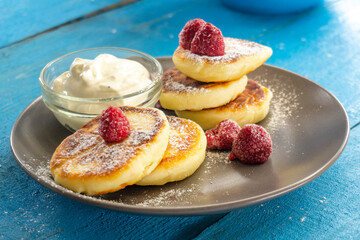 Cottage cheese pancakes or curd fritters. sirniki. Breakfast with cheesecake, fresh berries. food concept