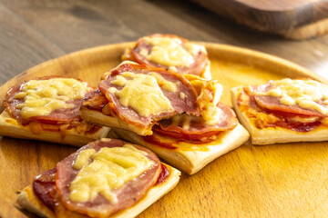 puff pastry mini pizza on a wooden background. food concept