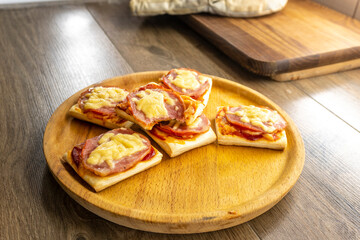 puff pastry mini pizza on a wooden background. food concept