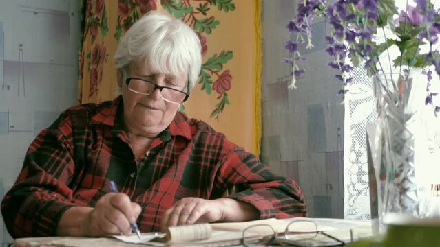 the old woman considers the payment documents.social inequality