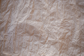 High detail of the abstract texture of the packaging paper. The texture of crumpled craft paper. Crumpled paper background top view.