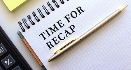 Notepad with text TIME FOR RECAP, next to it lies a calculator. Business concept.