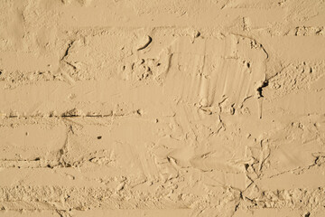 Texture of white painted brick wall close-up with sun.