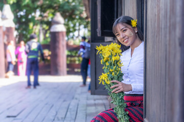 Beautiful happiness smile woman in Mandalay, Myanmar wearing traditional dressing have apply powder...