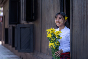 Beautiful happiness smile woman in Mandalay, Myanmar wearing traditional dressing have apply powder...