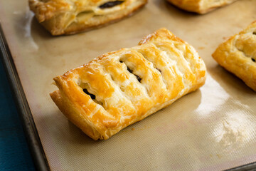 puff pastry poppy seads tarts on a wooden surface. food concept