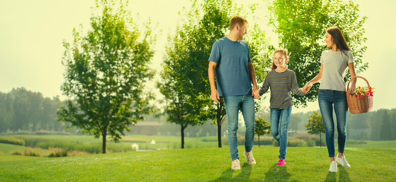 Portrait photo of wallking at picnic cheerful family, outdoors. Happy childhood and summertime concept. Copy space for ad text or slogan. Sunny day picture. Horizontal banner composition image.