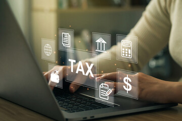 Financial research, government taxes, and calculation tax return concept. Business Woman using the laptop to fill in the income tax online return form for payment.Calculation tax return. tax and vat