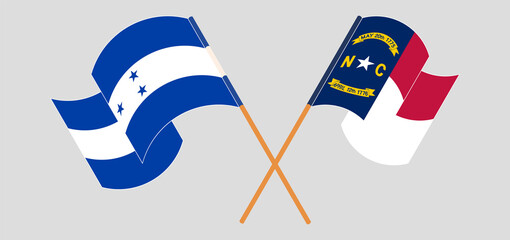 Crossed and waving flags of Honduras and The State of North Carolina
