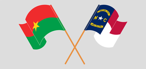 Crossed and waving flags of Burkina Faso and The State of North Carolina