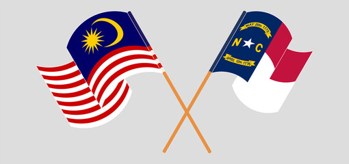 Crossed and waving flags of Malaysia and The State of North Carolina