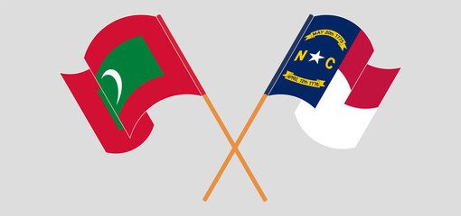 Crossed and waving flags of Maldives and The State of North Carolina