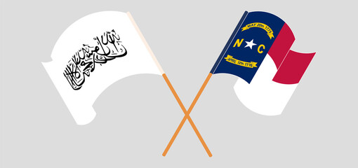 Crossed and waving flags of Taliban and The State of North Carolina