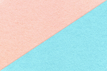 Texture of craft light blue and pink paper background, half two colors, macro. Vintage dense kraft rose cardboard.