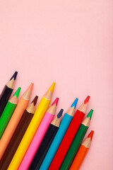 Color pencils on pink background. Vertical photo.