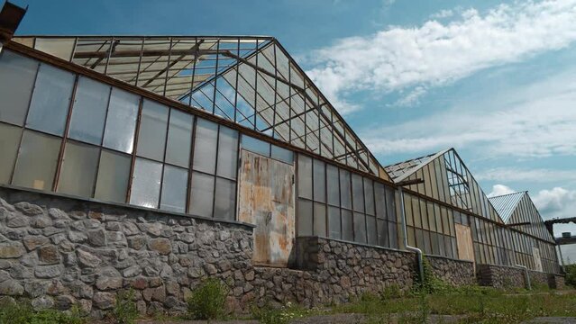 Old abandoned greenhouses with broken glasses