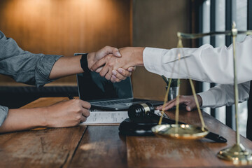 Business people shaking hands, finishing up a papers signing. Meeting, contract and lawyer consulting concept.