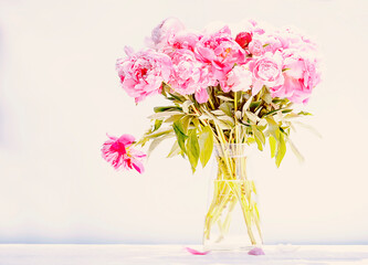 Bouquet of pink peonies on a light background.
Vintage style