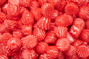 Red round tasty gummy candies as a background.