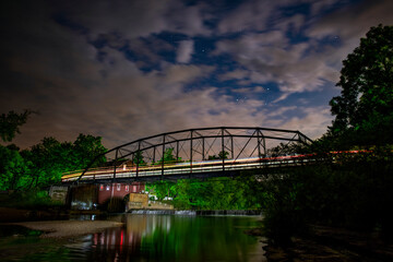 War Eagle Bridge with cars going across at night