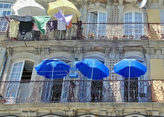 Colorful sun umbrellas on traditional Porto balconies - Portugal 