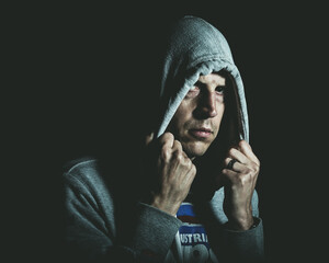 A man looks out from under a hoody