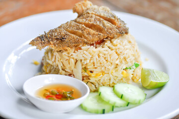 stir fried rice or fried rice with fried fish topping , fish and rice
