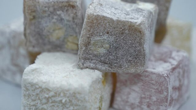 A close up view of stacked up Turkish delights and nougats.