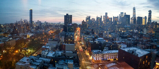 Panoramic view of the New York City skyline with the lights from the buildings shining across the cityscape