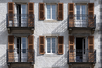 Fototapeta na wymiar Classic facade with balconies and window shutters in Chamonix France