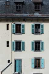 Fototapeta na wymiar Classic Chamonix apartment building facade with shuttered windows