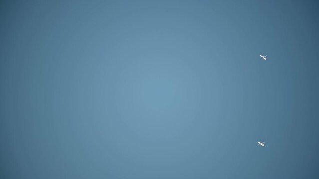 Two Planes flying in parallel high in the Sky