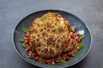 whole roasted oven baked cauliflower with spicy herbs 