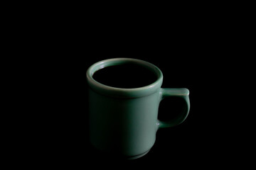 green cup of coffee isolated black color