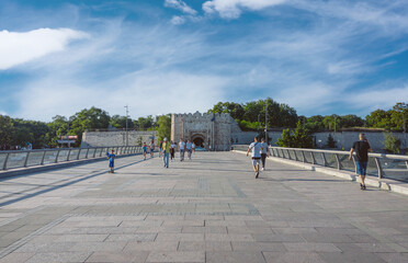 The city of Nis in Serbia. Big pedestrian bridge on the river Nisava with the old medieval fortress in the background.