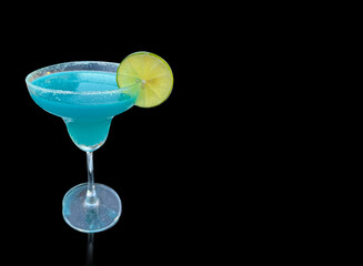 Youth fresh alcohol blue Hawaii cocktail with licor curacao, ice cube, lemon slice, yellow straw in wine glass on mint background, white wood board. in glasses with salt rim