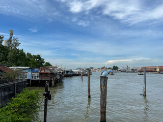 Bangkok, Thailand – June 18, 2022: Tha Maharaj Ferry Pier and Shophouses along the Chao Phraya River in Bangkok, Thailand, Asia